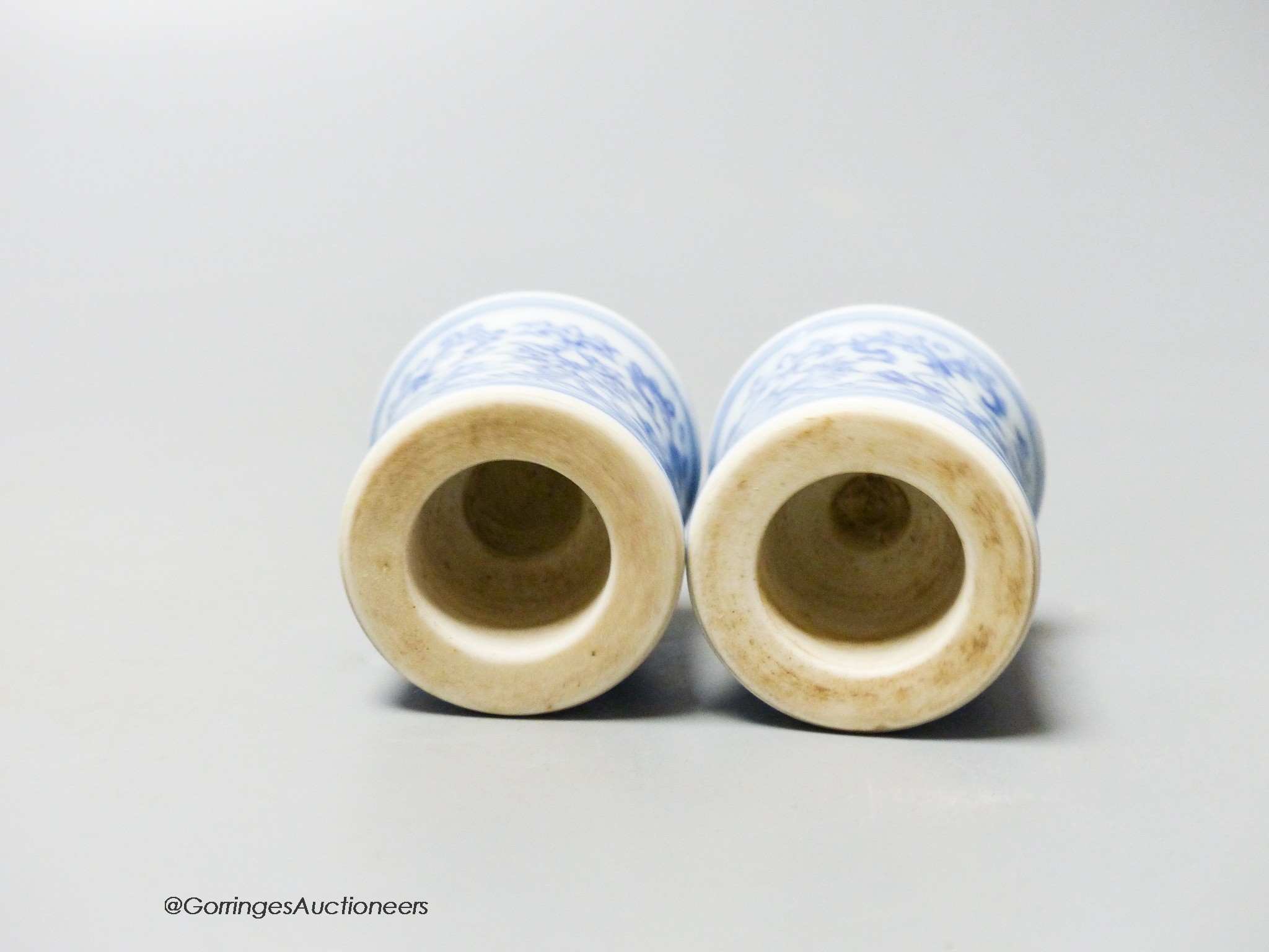 A pair of Chinese blue and white scroll ends, height 3.5cm